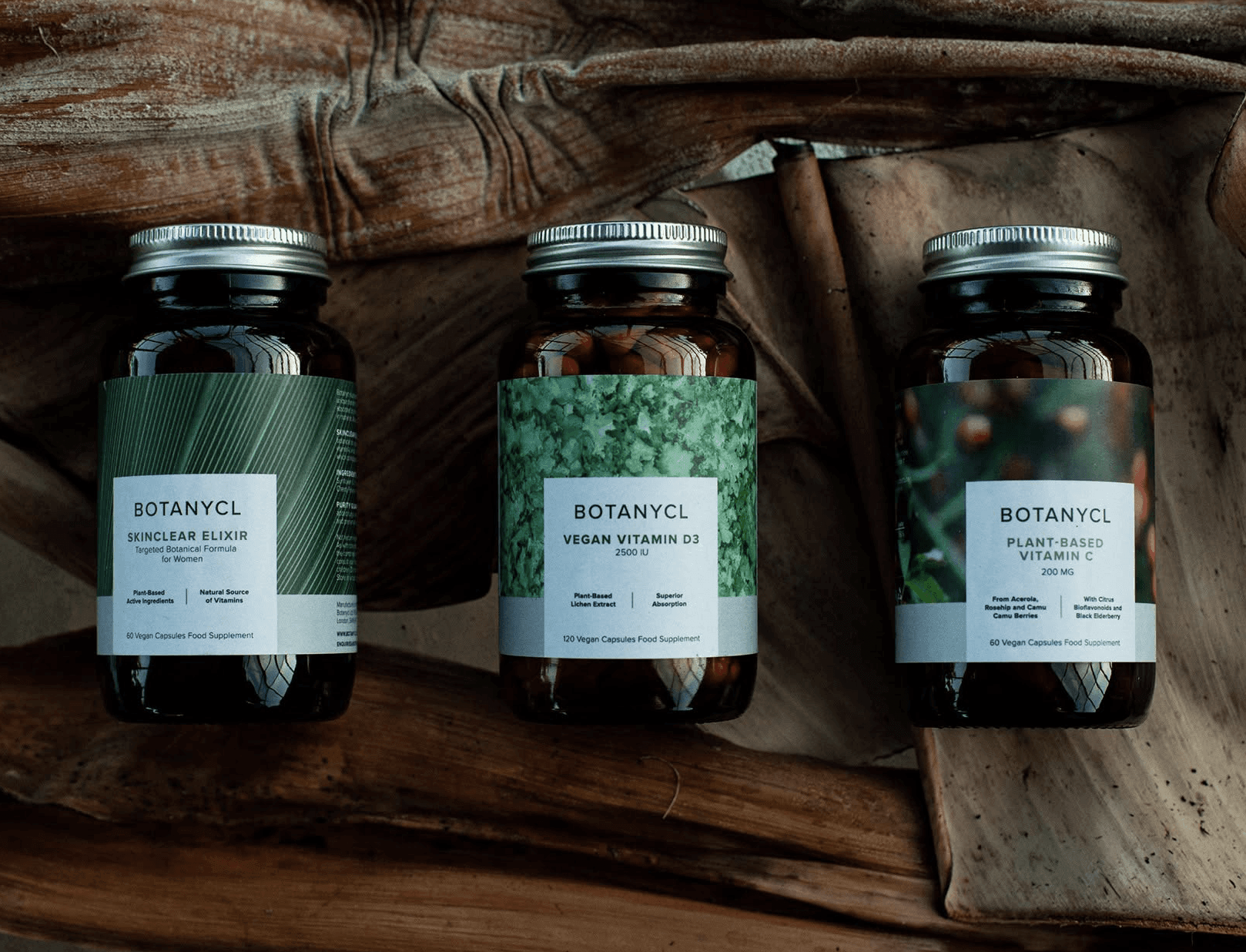 Botanycl plant-based supplements in amber glass jars — SkinClear Elixir, Vegan Vitamin D3 and Plant-Based Vitamin C